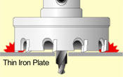 The tungsten carbide/ultra-hard tip of the hole saw starts drilling the work material.